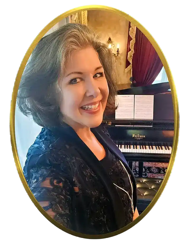 Julie Westfall smiling at a Baldwin grand piano in an elegant period room
